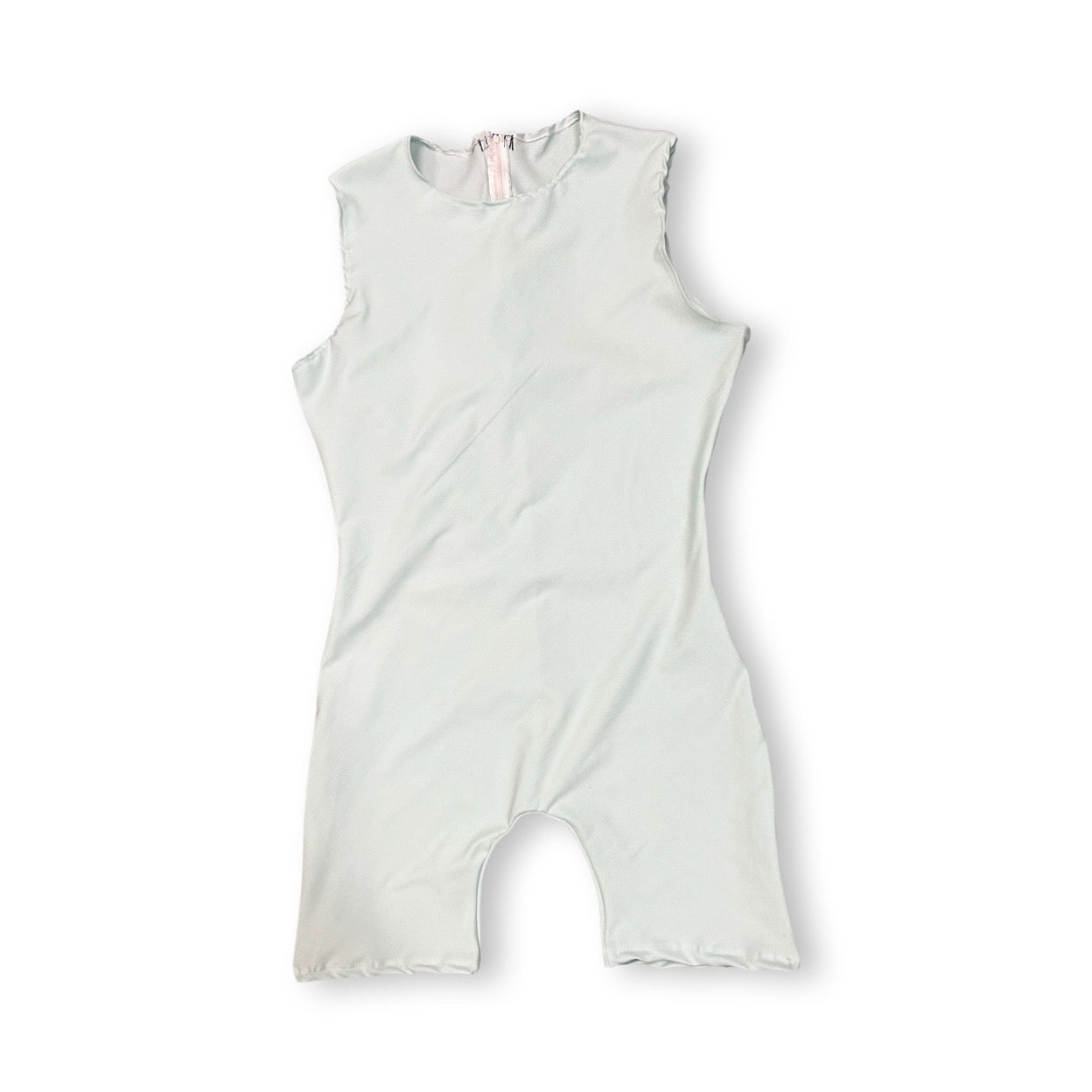 Baby's white swimsuit with pink trim, labeled Anti Strip Bodysuit Ultimate Protection