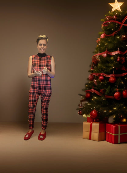 Holiday spirit exudes from woman in plaid jumpsuit by Christmas tree