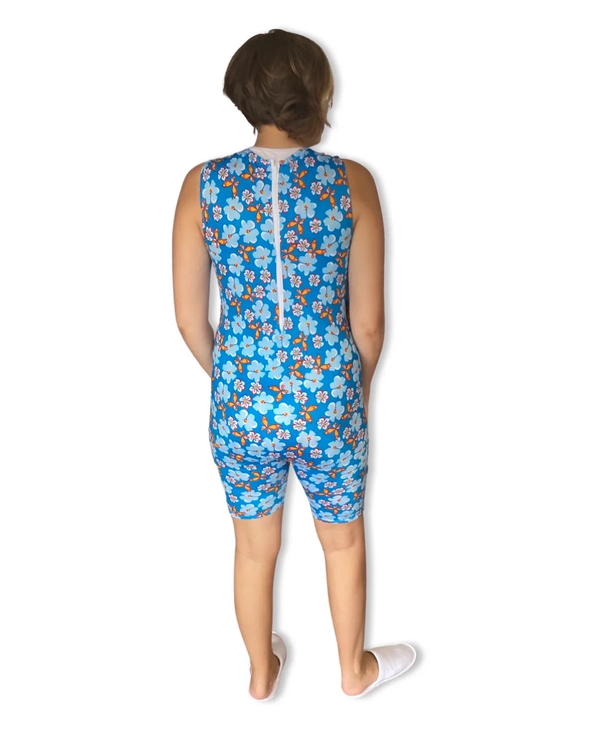 A female in a blue floral print swimsuit, designed for special needs individuals