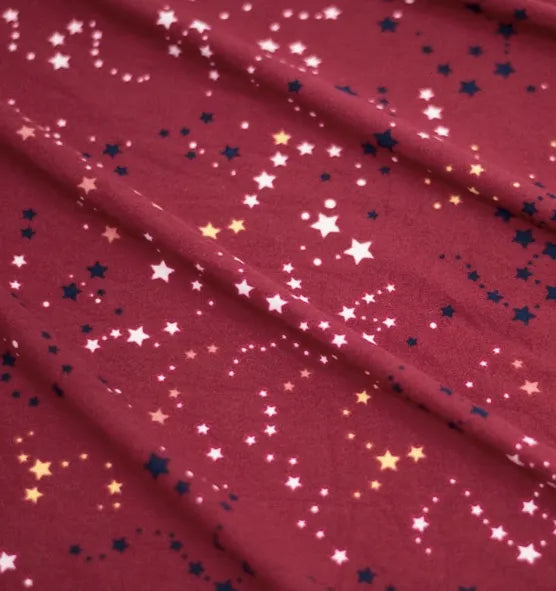 A fabric with a red and gold star print, perfect for Girls and Womens Onesies Stylish Colors and Sleeves