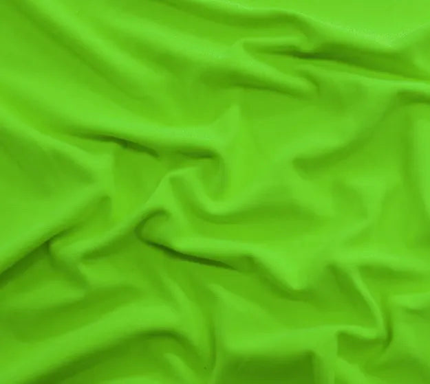 A close-up of a green fabric with numerous folds, creating an intricate texture